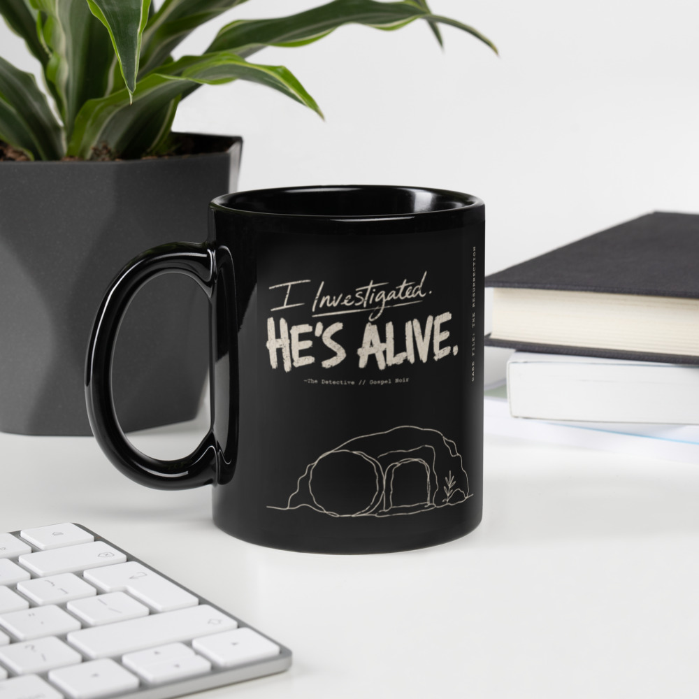 I Investigated. He’s Alive. Black Christian Mug – 11 oz — black, left handle on left. Gospel Noir Christian coffee mug by Heavenly Crafted, Bible verse coffee mug
